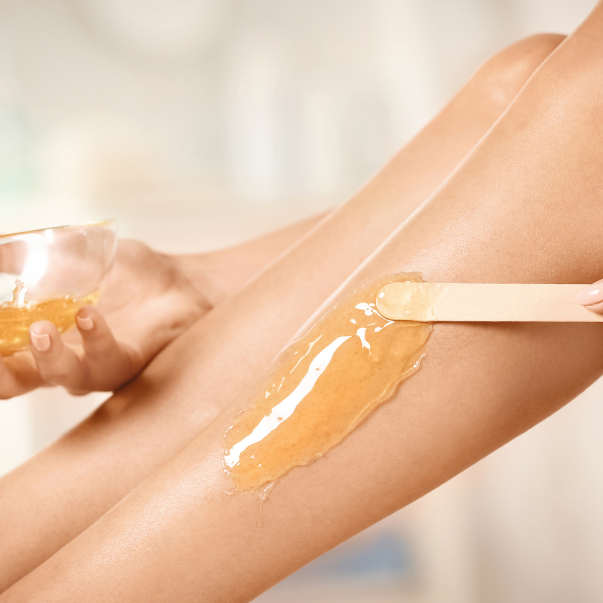 Depil Bella Honey Wax Beads application on leg for smooth skin.